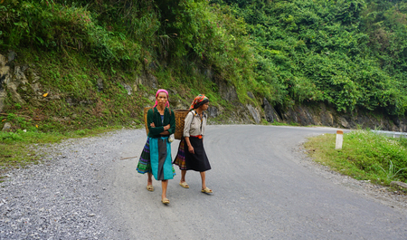Mu Cang Chai, Vietnam - June 12, 2015. Women of Hmong walking on the local road in Yen Bai, Vietnam. They going rice field in transplant season.のeditorial素材