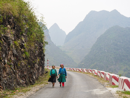 HA GIANG, VIETNAM - SEP 2, 2015. People walking on countryside road to coming home after finish work in Ha Giang, north of Viet Nam.のeditorial素材