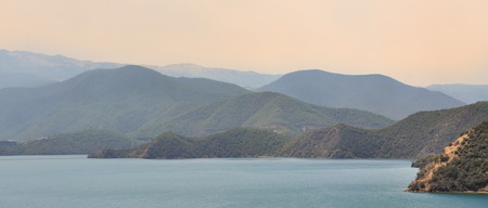 Landscape of Lugu lake with the mountain background in Yunnan, China. The lake is surrounded by mountains and has 5 islands, 4 peninsulas.の写真素材