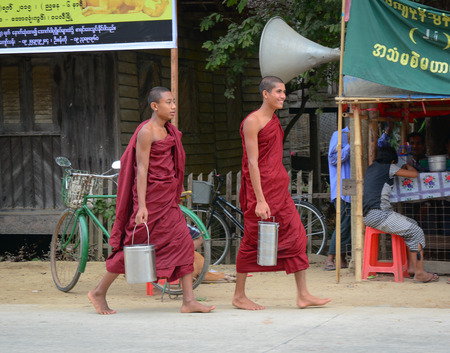 BAGAN, MYANMAR - OCT 1, 2015. Burmese young novice monks walking morning alms in Old Bagan, Myanmar. 89% of the Burmese population is Buddhist.のeditorial素材