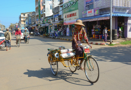 MANDALAY, MYANMAR - OCTOBER 1, 2015. People ride tricycle on the streets in the center of the Mandalay, Myanmar (Burma).のeditorial素材