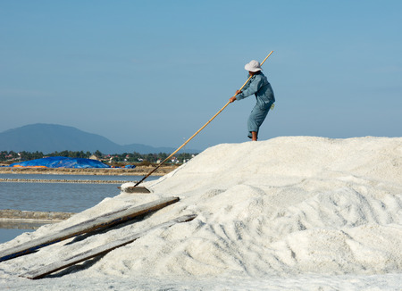 Nha Trang, Vietnam - June 12, 2015. Vietnamese people working on the salt fields in Ninh Hoa. About 40 kilometers north of Nha Trang, there are immense salt fields.のeditorial素材