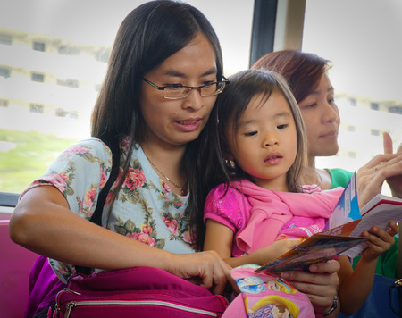 SINGAPORE - FEBRUARY 18, 2015. Passengers in the train MRT. Singapore subway, also known as MRT, started operating in 1987. It is network length is 130 kms, it has 87 stations and 4 lines.のeditorial素材