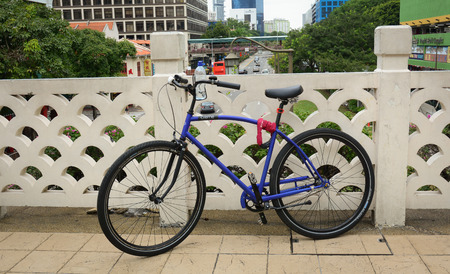 SINGAPORE - FEB 11, 2015. An old bicycle locked on the street in Singapore. A former British colony the city state has the world's 3rd highest GDP and is home to 5.4mn people.のeditorial素材