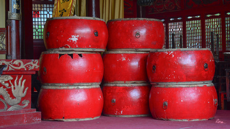 KUNMING, CHINA - NOV 10, 2015. Asian wooden leather old drums at the temple in Kunming city, China.の写真素材
