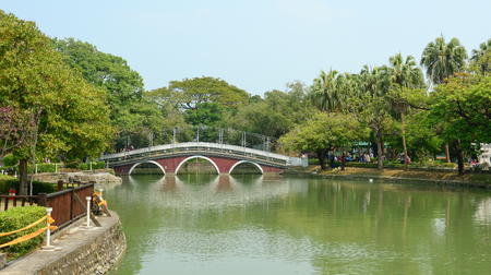 Red bridge and green lake at Taichung Park, Taiwan.の写真素材