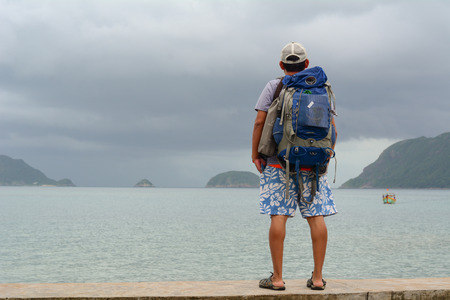 Con Dao, Vietnam - Oct 22, 2015. Young men standing and seeing the sea at Con Dao island, Vietnam.のeditorial素材