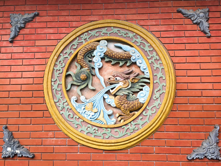 Beijing, China - Apr 12, 2015. Artwork with dragons on a wall of an ancient Buddhist temple, Beijing, China.のeditorial素材