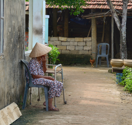 HOI AN, VIETNAM - MARCH 15, 2015. Unidentified woman selling souvenirs at walking street of old town with old aged traditionally kept cultural activities in Hoi An, Vietnam.のeditorial素材