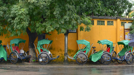 HOI AN, VIETNAM - NOV 14, 2015. Cyclo parked on the side street at Hoi An, Vietnam. Hoi An is a tourist attraction because of its history, traditional architecture and crafts such as textiles and ceramics.のeditorial素材