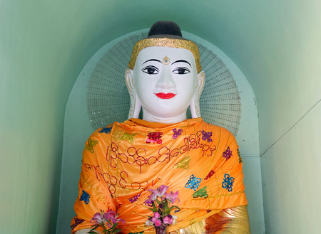 White Buddha statue in Shwedagon Paya in Yangon, Myanmar.の写真素材