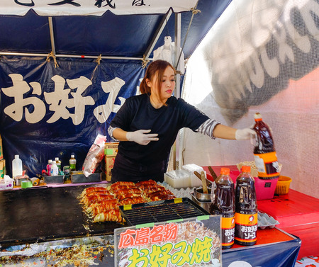 Nikko, Japan - Jan 2, 2016. A woman selling street foods in Nikko, Japan.のeditorial素材