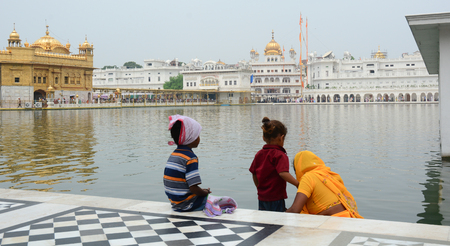 Amritsar, India - Jul 25, 2015. Sikh people take water on the holy lake at Golden Temple in Amritsar, India.のeditorial素材