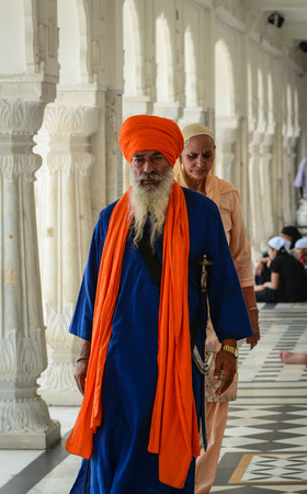 Amritsar, India - Jul 25, 2015. Sikh people in traditional clothes walking at the Golden Temple in...