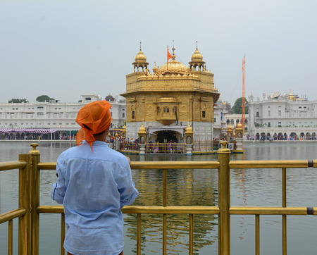 Amritsar, India - Jul 25, 2015. A tourist standing and looking at the Golden Temple in Amritsar,...
