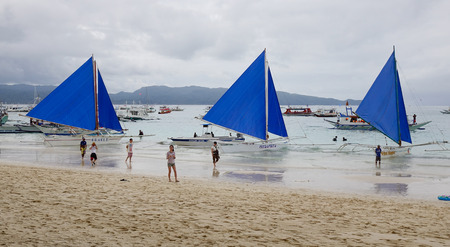 Boracay, Philippines - Dec 17, 2015. Blue sailboats on White beach in Boracay, Philippines.のeditorial素材