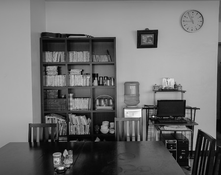 Manila, Philippines - Dec 20, 2015. Black and white living room with table and bookcase in modern house in Manila, Philippines.のeditorial素材