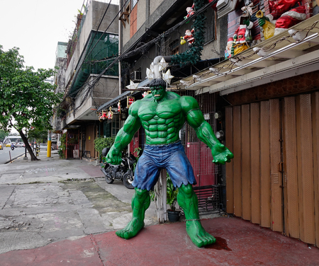 Manila, Philippines - Dec 20, 2015. Superhero statue at slum region in Manila, Philippines. Manila is a Philippines capital with very strong contrasts in standard of living.のeditorial素材
