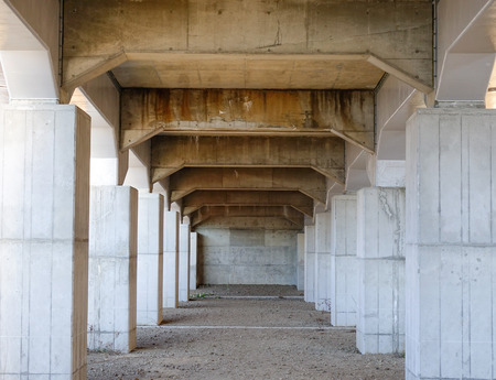 Colonnade of the vertical supports under the bridge.