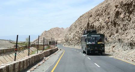 Ladakh, India - Jul 17, 2015. A local bus running pass the road on high altitude Ladakh-Leh road in Himalayan mountain, state of Jammu and Kashmir, India.のeditorial素材
