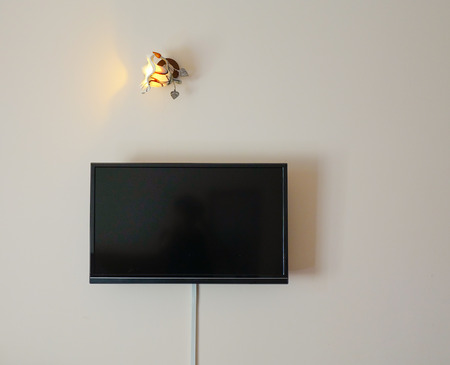 Black LED tv television screen hanging on the wall in an old room
