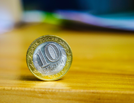 Russian money - 10 rubles coins on the wooden table, closed up.の写真素材