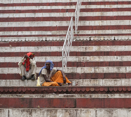 Varanasi, India - Jul 12, 2015. People sitting and praying on the ghat in Varanasi, India. Varanasi is a holy Indian city of the banks of the Ganga in Uttra Pradesh, India.のeditorial素材