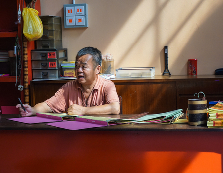 Kuala Lumpur, Malaysia - Jun 6, 2015. A man sitting at Chinese temple in Chinatown, Kuala Lumpur, Malaysia.のeditorial素材