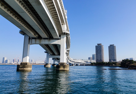 Tokyo, Japan - Jan 4, 2016. Rainbow Bridge at sunny day in Odaiba District, Tokyo Bay, Japan. A number of Japan's most important ports are located in Tokyo Bay.のeditorial素材