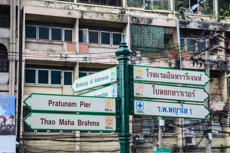 Bangkok, Thailand - Nov 10, 2015. Close up of bilingual direction signpost in Bangkok, Thailand.のeditorial素材