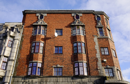 Facade of red brick apartment in Vyborg city, Russia. Vyborg is an important transport junction in the Northwest region of Russia.の写真素材