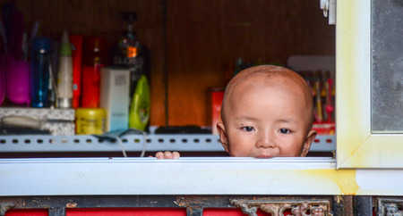 Leh, India - Jul 22, 2015. A Tibetan child at home in Nubra Valley, India. 65% of children attend school, but absenteeism of both students and teachers remains high.のeditorial素材