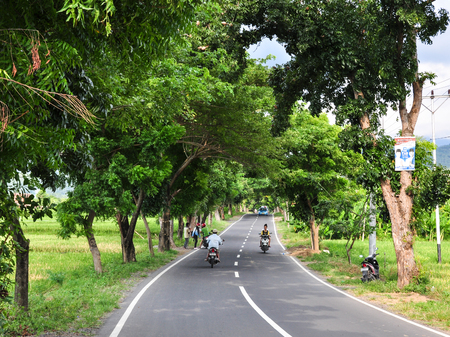 Lombok, Indonesia - Apr 26, 2013. Rural road in Lombok Island, Indonesia. Lombok is an island next to Bali where the tourism is still in its infancy.のeditorial素材