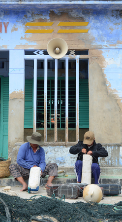 Ninh Thuan, Vietnam - Jan 27, 2016. Men working with fishing nets in the village in Phan Rang, Vietnam. Phan Rang is one of famous destinations in southern Vietnam.のeditorial素材