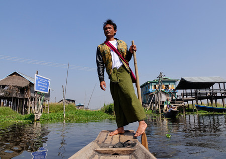 Inle, Myanmar - Feb 14, 2016. A man rowing wooden boat on the canal in Inle, Myanmar. Inle Lake is a freshwater lake located in the Nyaungshwe Township of Shan State.のeditorial素材
