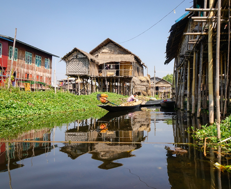 Inle, Myanmar - Feb 14, 2016. Burmese people rowing wooden boat on the canal in Inle, Myanmar. Inle Lake is a freshwater lake located in the Nyaungshwe Township of Shan State.のeditorial素材