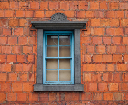 Red brick wall with an old window at the old temple in Asia.の写真素材