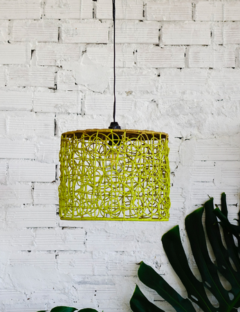 Hanging light bulb with old white brick wall background at home.の写真素材