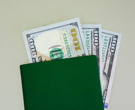 American banknotes (100 US dollars) with green passport - close up.の写真素材