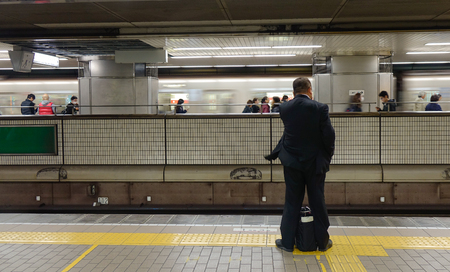 Tokyo, Japan - Nov 24, 2016. A man waiting at the metro station in Tokyo, Japan. In 2014, Tokyo Metro had an average daily ridership of 6.84 million passengers.のeditorial素材