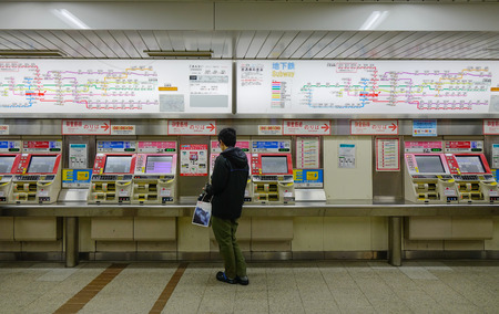 Tokyo, Japan - Nov 24, 2016. A man buying tickets at the metro station in Tokyo, Japan. In 2014, Tokyo Metro had an average daily ridership of 6.84 million passengers.のeditorial素材