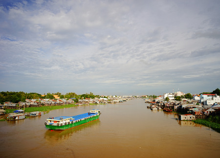 An Giang, Vietnam - Aug 8, 2016. Floating village and cargo boats on Bassac River, Chau Doc, An Giang, Vietnam. The Bassac River is a distributary of the Tonle Sap and Mekong River.のeditorial素材