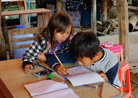 INLE LAKE, MYANMAR - FEB 15, 2015. Children studying with books in Inle Lake, Myanmar (Burma). Inle is one of the highest lakes at an elevation of 2,900 feet (880m).のeditorial素材
