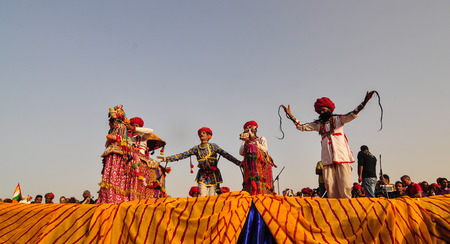 PUSHKAR, INDIA - MAR 7, 2012. Rajasthani folk dancers in colorful ethnic attire perform in Pushkar, India. Pushkar, a rare combination of sand dunes, lake, hills and forest.のeditorial素材