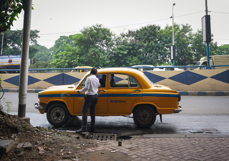 Kolkata, India - Jul 8, 2015. A man taking taxi on street in Kolkata, India. Kolkata is the largest city in Eastern India, as well as in the historical region of Bengal.のeditorial素材