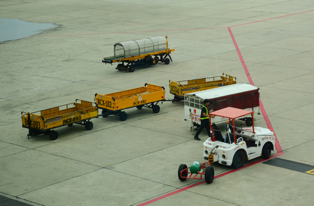 Bangkok, Thailand - Jun 18, 2016. Vehicles on runway at Don Muang Intl Airport in Bangkok, Thailand. Bangkok is a large city known for ornate shrines and vibrant street life.のeditorial素材