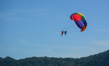 Phuket, Thailand - Jun 19, 2016. People playing parasailing at the sunny day in Phuket, Thailand. Phuket, a rainforested, mountainous island in the Andaman Sea.のeditorial素材