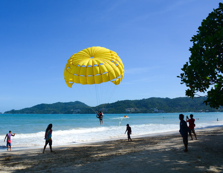 Phuket, Thailand - Jun 19, 2016. Tourists playing parasailing on Patong beach in Phuket, Thailand. Patong is a beach resort town on the west coast of Phuket Island.のeditorial素材