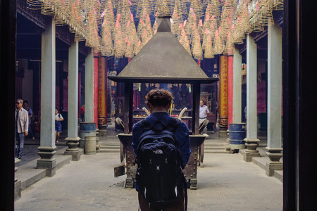 Saigon, Vietnam - Jan 30, 2017. A young man praying at Jade Emperor Temple in Saigon, Vietnam. The pagoda was built at the turn of the 20th Century by a community of Cantonese.のeditorial素材