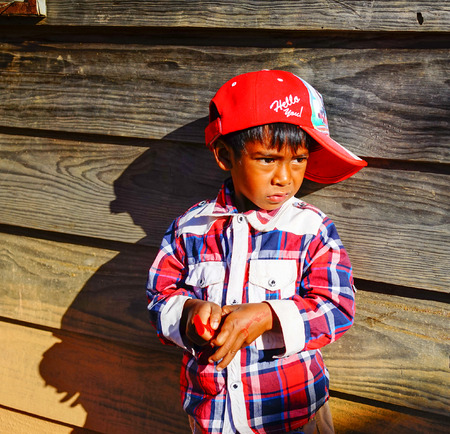 Dalat, Vietnam  - Dec 5, 2015. A Koho ethnic boy standing at the wooden house in Dalat, Vietnam. Koho are an ethnic group living in the Dalat township of Central Highlands.のeditorial素材